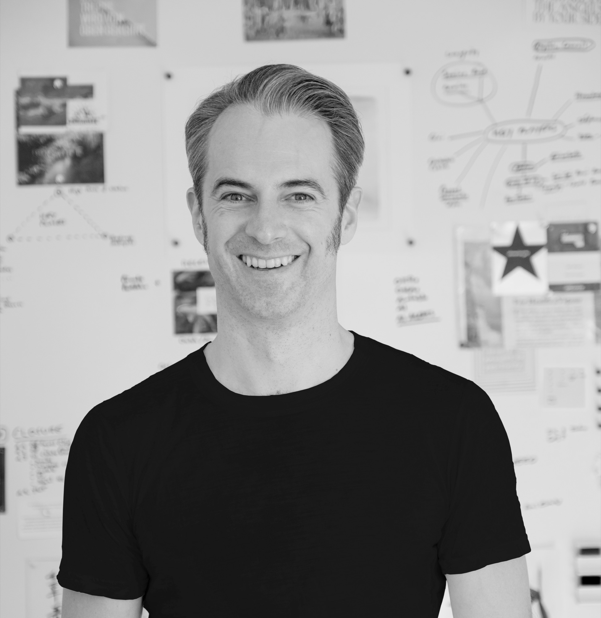 Jan Bruch in front of a wall of notes, sketches and diagrams.
